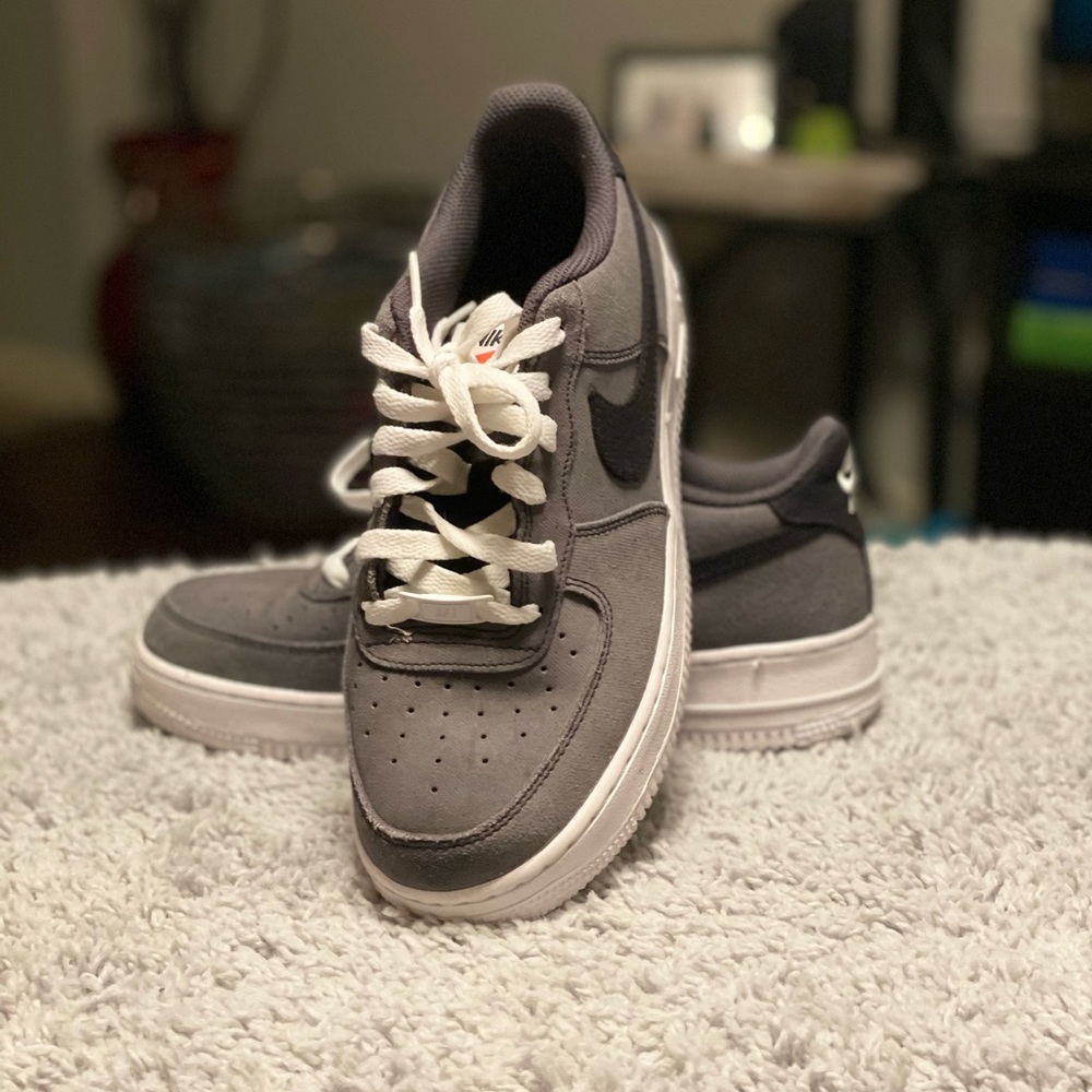 Gray, white, and black Nike Air Force One’s